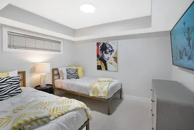 a bedroom with two beds and a table in it at Life Is Gucci! Gorgeous WATER VIEWS Miami Condo! in Miami