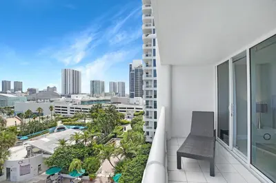 a balcony with a chair and a view of the city at Life Is Gucci! Gorgeous WATER VIEWS Miami Condo! in Miami