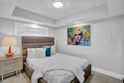 a bedroom with a bed and a painting on the wall at Big Energy! Water Views and Newly Renovated! in Miami