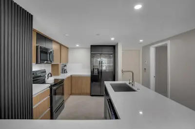 a large kitchen with a sink and a refrigerator at Visions! Water and Miami Skyline VIews! Brand New in Miami