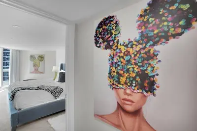 a room with a painting of a woman with a head at Visions! Water and Miami Skyline VIews! Brand New in Miami