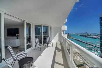 a balcony with chairs and a view of the water at Visions! Water and Miami Skyline VIews! Brand New in Miami