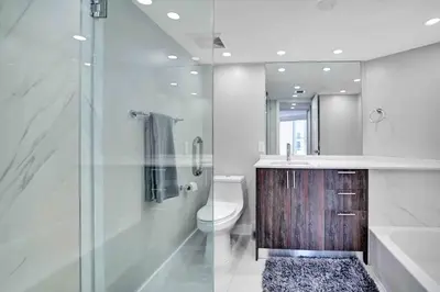 a bathroom with a toilet and a glass shower at Summer Retreat! Water and City Views! in Miami