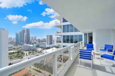 a balcony with blue chairs and a view of the city at Summer Retreat! Water and City Views! in Miami