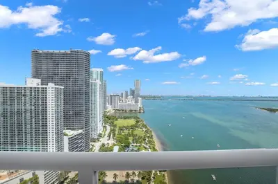 a view of the ocean from the balcony of a building at Velvet Sky! Water & Park Views! in Miami