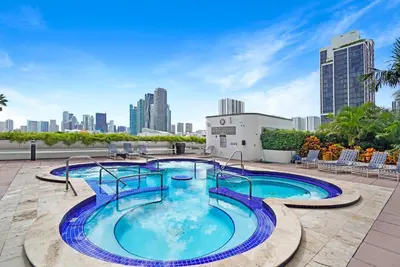 a swimming pool on the roof of a building with a city at Day Dreamer! Water & Miami City Views! in Miami