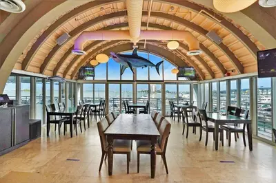 a restaurant with tables and chairs and a large room with windows at Day Dreamer! Water & Miami City Views! in Miami