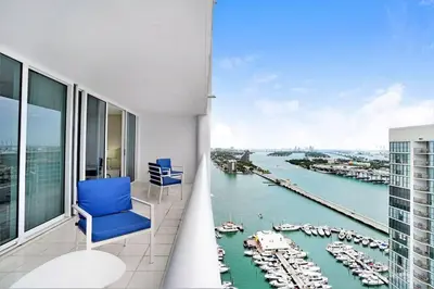 a room with a blue chair and a view of a harbor at Day Dreamer! Water & Miami City Views! in Miami