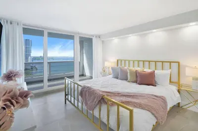 a bedroom with a large bed and a large window at Sweet Dreams! Renovated with Water Views in Miami