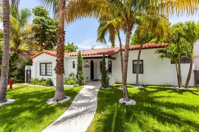 a house with palm trees in front of it at Bars B&B South Beach Hotel in Miami Beach