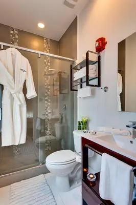 a bathroom with a shower and a toilet and a sink at Bars B&B South Beach Hotel in Miami Beach