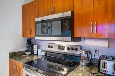 a kitchen with a stove and a microwave at Modern Bayview Apartment in Brickell Bay in Miami