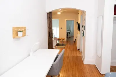 a hallway with white walls and a white table and chairs at Homey Little Havana Apt Centrally located Hv4 in Miami