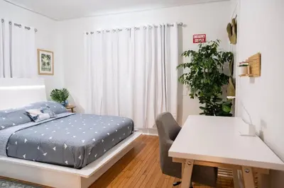 a bedroom with a bed and a desk and a table at Homey Little Havana Apt Centrally located Hv4 in Miami