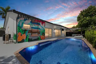 a house with a swimming pool in the yard at Flamingo's Resort -Htd Pool, 5 Bedrooms, Game Room, Baby Items , BBQ in Miami
