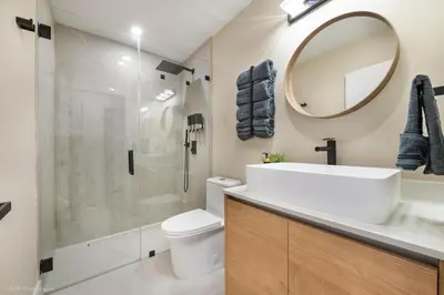 a bathroom with a toilet and a sink and a mirror at Flamingo's Resort -Htd Pool, 5 Bedrooms, Game Room, Baby Items , BBQ in Miami