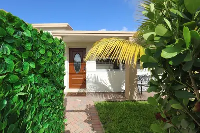 a house with a palm tree in the yard at Home away from home in Hollywood