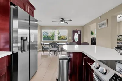 a kitchen with a refrigerator and a dining room at Home away from home in Hollywood