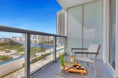 a balcony with a view of the city and the ocean at Sunset Oasis with 2BR, Balcony, Pool, Perfect Getaway in Hallandale Beach