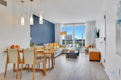 a living room with a table and a couch at Sunset Oasis with 2BR, Balcony, Pool, Perfect Getaway in Hallandale Beach