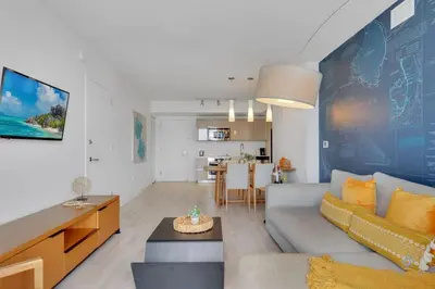 a living room with a couch and a table at Sunset Oasis with 2BR, Balcony, Pool, Perfect Getaway in Hallandale Beach