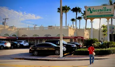 a man walking in front of a car dealership at Cute Private Room, near the Airport - Free parking - 02 in Miami