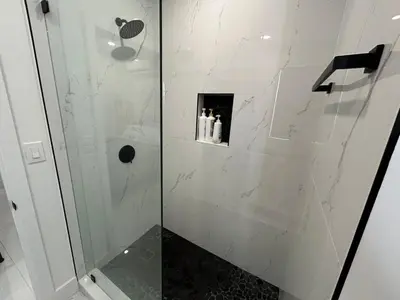 a bathroom with a shower with a glass door at Cozy Private Room, near the Airport - Free parking - 02 in Miami