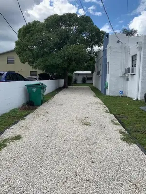 a driveway in front of a house with a tree at Cozy Private Room, near the Airport - Free parking - 02 in Miami