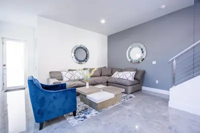 a living room with a couch and a table at Modern 4-Bedroom Townhouse with Pool! in Miami