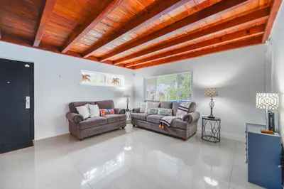 a living room with two couches and a television at Discover Serenity in this Tranquil Miami Home in Miami