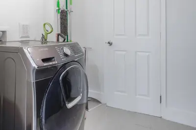 a washing machine with its door open in a room at Discover Serenity in this Tranquil Miami Home in Miami