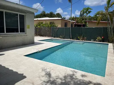 a swimming pool in the backyard of a house at Discover Serenity in this Tranquil Miami Home in Miami