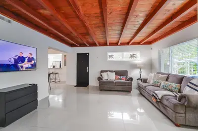 a living room with a couch and a flat screen tv at Discover Serenity in this Tranquil Miami Home in Miami