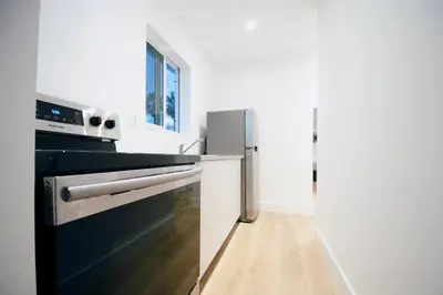 a kitchen with a stove and a refrigerator at Casa Canal in North Miami Beach