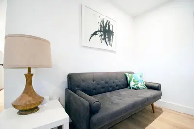 a living room with a couch and a lamp on a table at Casa Canal in North Miami Beach