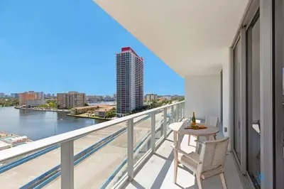 a balcony with a table and chairs and a view of the river at Wrap Around BalconyParadise Beach Amazing Pools in Hollywood