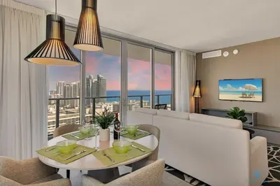 a living room with a white couch and a table at High Floor with Stunning View Pools Near Beach in Hollywood