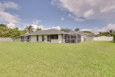 a house with a large lawn in front of it at Pet-Friendly Miami Home with Hot Tub and Pool Table in Miami