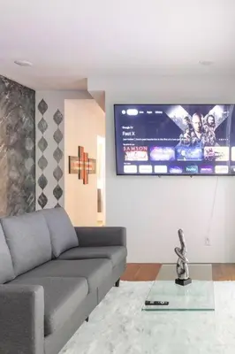 a living room with a couch and a tv at Blue Ocean Vacation Home 1 in Fort Lauderdale