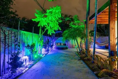 a garden lit up at night with green and purple lights at Blue Ocean Vacation Home 1 in Fort Lauderdale