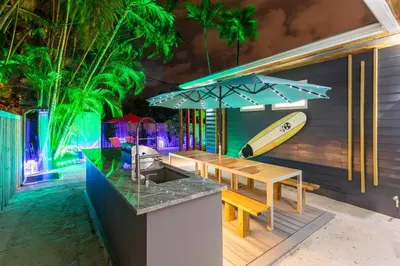 a kitchen with a counter with a surfboard on the wall at Blue Ocean Vacation Home 1 in Fort Lauderdale