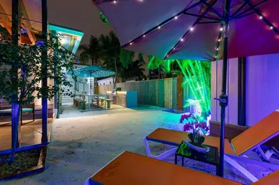 a patio with a table and an umbrella and lights at Blue Ocean Vacation Home 1 in Fort Lauderdale