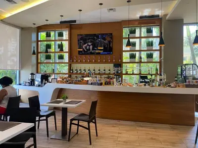 a bar in a restaurant with tables and chairs at Relaxing BeachWalk Getaway, Studio for 4 Guests in Hallandale Beach