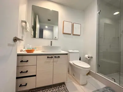 a bathroom with a toilet and a sink and a shower at 2 Full Beds Ocean Air, Relaxing Studio Stay in Hallandale Beach