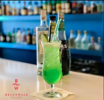 a green drink in a glass sitting on a table at Studio with 2 Full Beds, Perfect Beach Location in Hallandale Beach