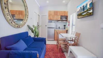 a living room with a blue couch and a table at Spectacular Apartment near Brickell in Miami