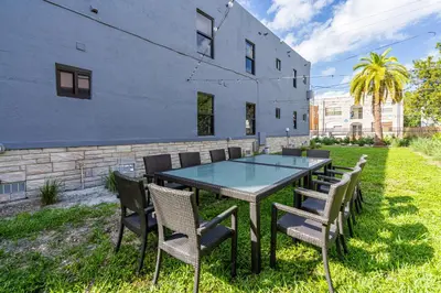 a table and chairs in a yard next to a building at Spectacular Apartment near Brickell in Miami
