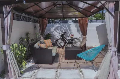a gazebo with a couch and a bicycle at Zoka House 5 mints from Brickell in Miami