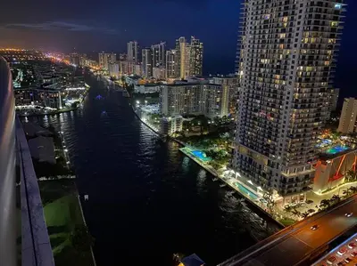a view of a city at night with a river at Premier Beach Escape with Spectacular Views -A in Hallandale Beach