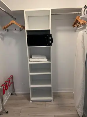 a walk in closet with a microwave and towels at Premier Beach Escape with Spectacular Views -A in Hallandale Beach